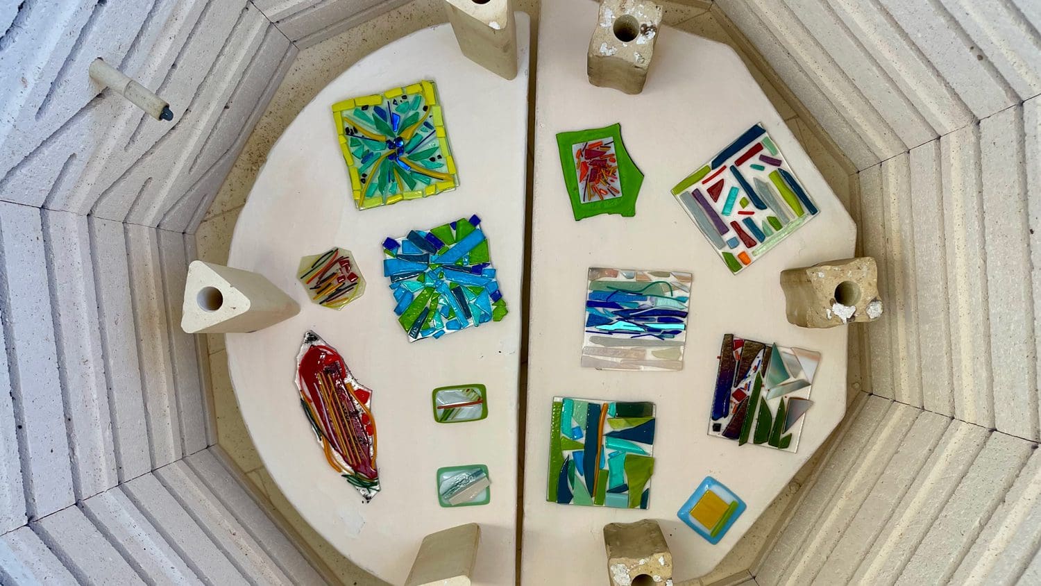 Colorful glass pieces in a kiln.