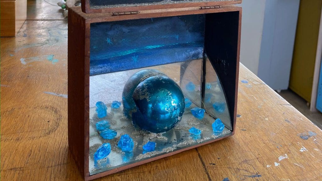 A beautiful artwork on a box with a sphere