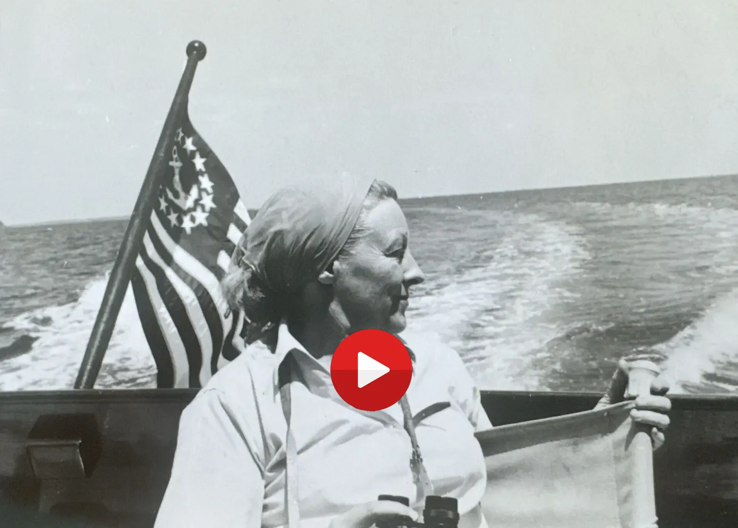 Woman on a boat with an American flag.