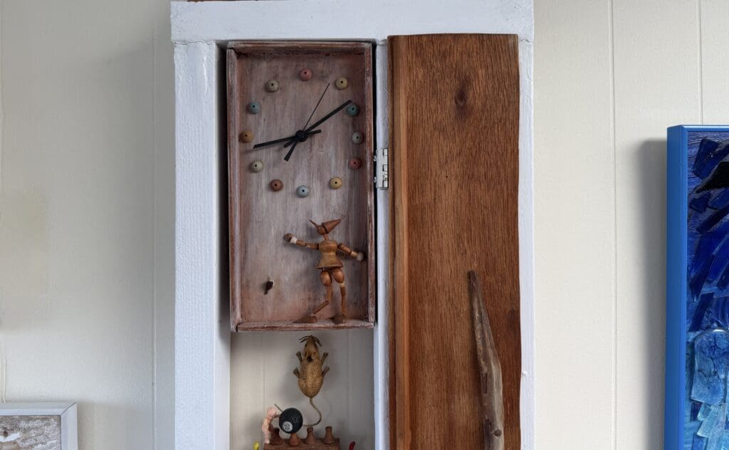 Whimsical clock with wooden figurines.