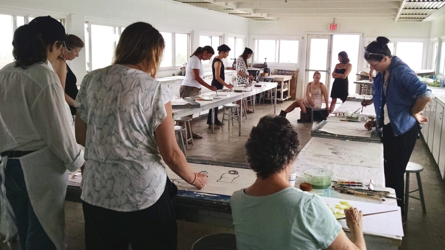 Women painting in art class studio.